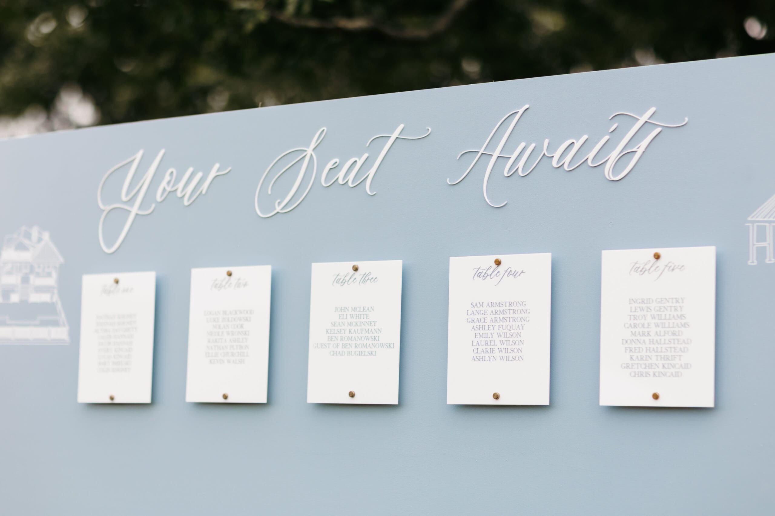 Image of a Wedding Seating Chart with the Words "Your Seat Awaits" with line drawings of important locations to the couple.