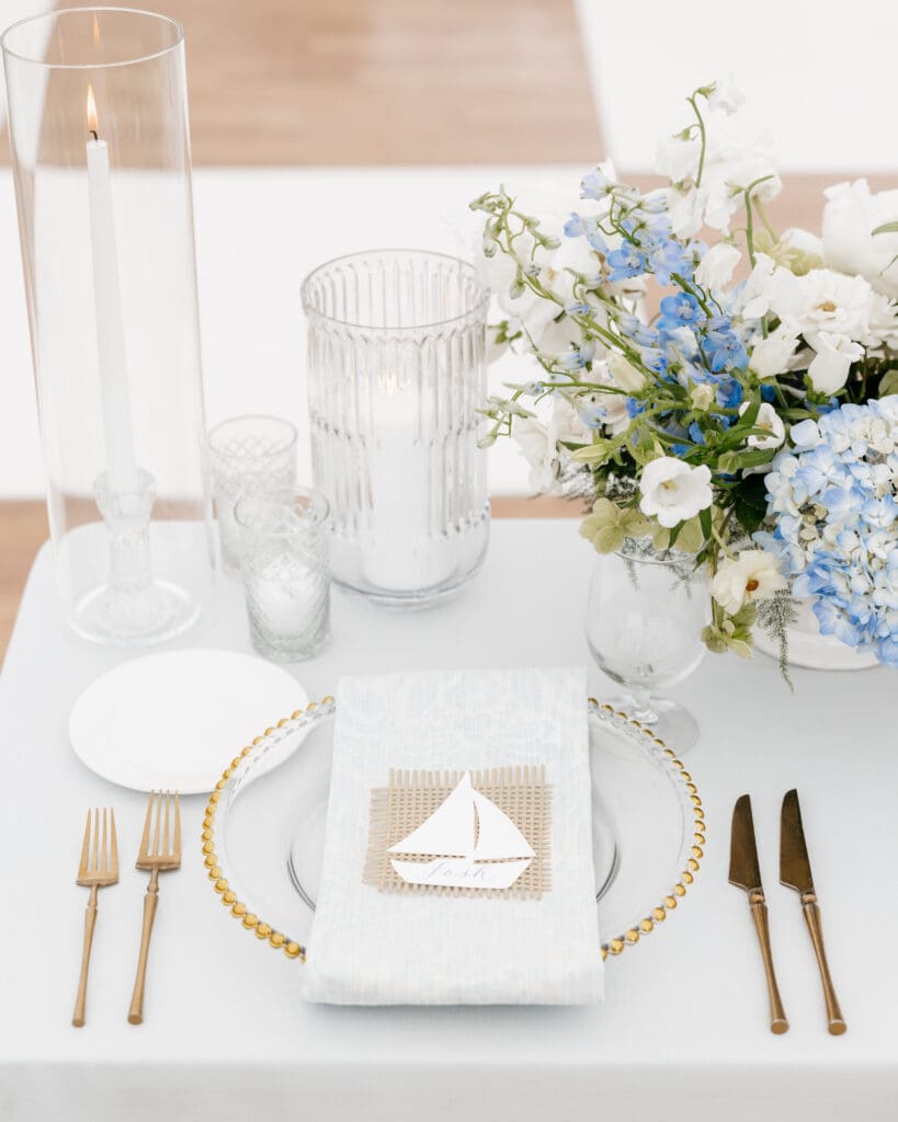 Image of place setting at wedding table with a calligraphy place card on top.